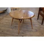 A beech and elm Ercol drop leaf side table on tapered legs