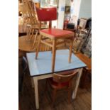 A painted pine formica topped table with teak chairs