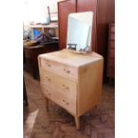 A bleach teak veneered dressing chest of three drawers,