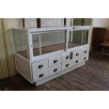 A painted vintage shop fitting glass top and sides with eight drawers to bottom