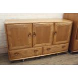 An Ercol beech and elm three door,