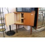 A mid Century teak two door cupboard on tapered legs