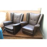 A pair of retro leather wing back armchairs