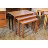 A nest of three teak tables