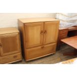 An Ercol beech and elm TV cabinet, fall to front,