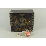 An early 20th Century Japanese lacquer six drawer table cabinet painted with exotic birds and