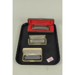 A cased Hohner 'The Chromonica' harmonica plus a 'Special 20' and a Tombo Lee Oskar in a Hohner