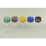 A part set of five vintage harlequin coloured cut to clear hock glasses,