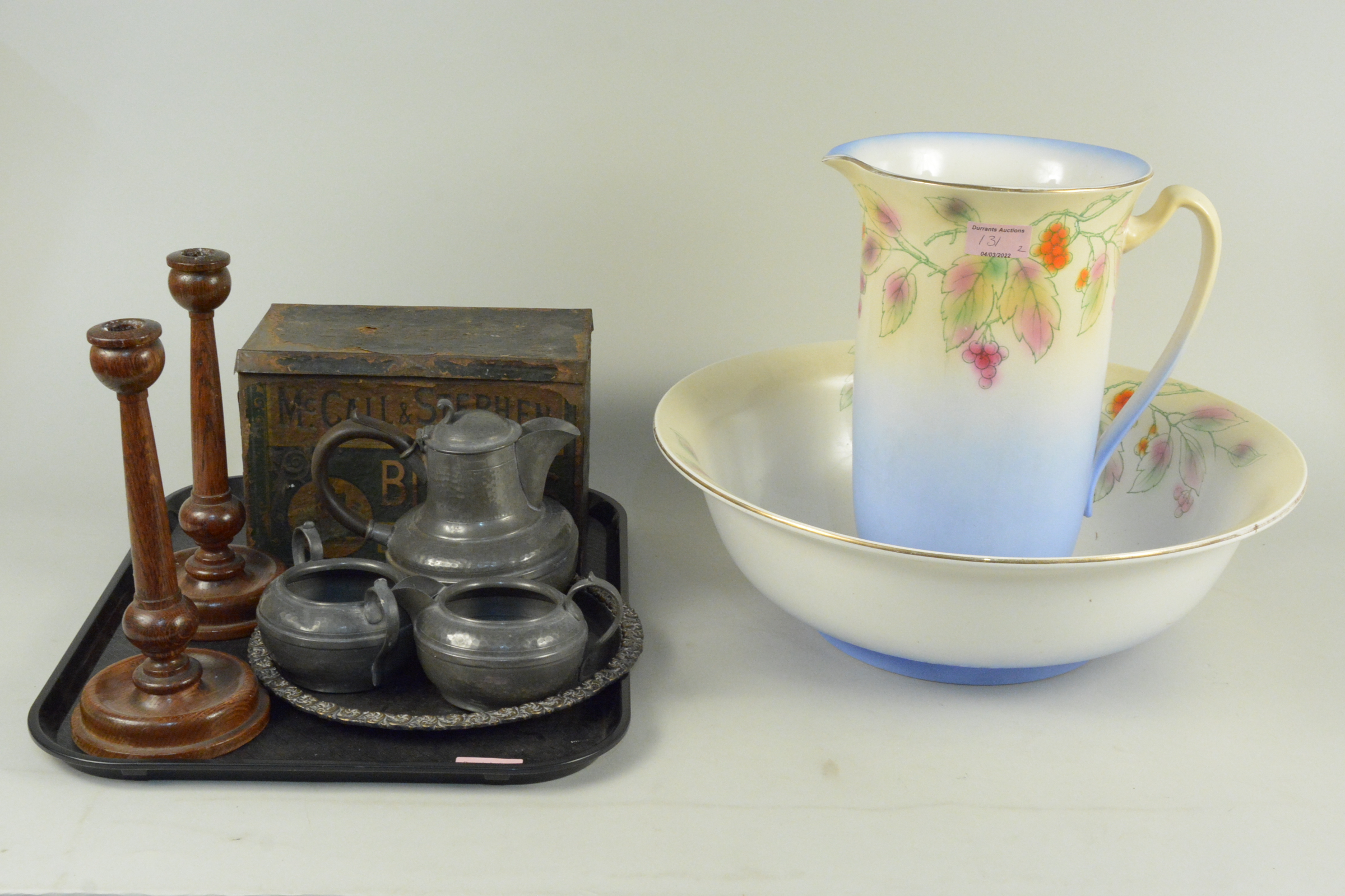 A mixed lot including a vintage McCall & Stephen biscuit tin, a three piece pewter tea set,