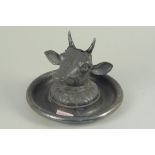 A large late 19th Century plated desk inkwell in the form of a cows head on a round base by Joseph