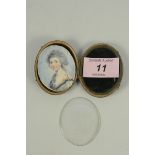 An early 19th Century cased oval miniature on ivory of a lady