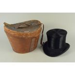 A top hat by Stanley of Cheapside with leather travelling case