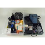 A tub of photographic accessories including film reels, tripod,