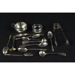 A mixed silver lot including five apostle spoons, Victorian sugar nips, Georgian condiment spoons,