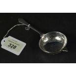 A silver tea strainer, hallmarked Birmingham 1938,