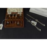 A pair of silver millennium hallmarked lobster picks plus a cased set of six silver coffee spoons,