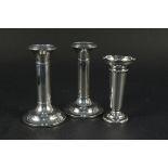 A pair of silver candlesticks (as found) plus a silver vase,