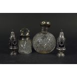 A mixed lot including a silver lidded cut glass scent bottle (lid loose) plus a pair of pepperettes,