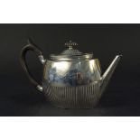 A Victorian silver teapot of half fluted design, engraved crest and monogram,