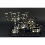 A collection of silver plated items including a pair of candelabra and a tea set etc