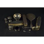 A selection of silver items including cruets, a small bowl, brushes and mirror,