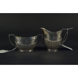 A Victorian silver sugar and milk jug, both of half fluted design with engraved monograms,