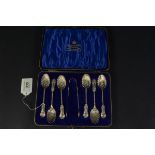 A cased set of six silver teaspoons and sugar tongs with shell shaped design,