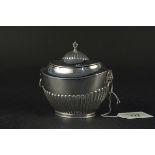 A silver tea caddy half fluted and mask decoration, hallmark to main body rubbed,