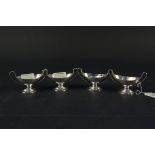 A set of four Victorian silver salts with twin handled design on pedestal base,