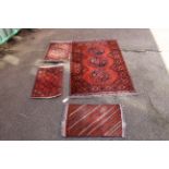 A handmade red ground rug,