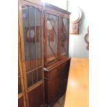 A 20th Century Sheriton style mahogany cupboard bookcase with astragal glazed doors,