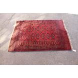 A red ground rug with central medallions,