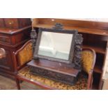 A late 19th Century heavily carved continental oak toilet mirror with drawer