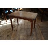 An Edwardian oak occasional table with carved edge