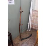 A vintage scythe with shaped ash handle