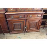 An Edwardian American walnut carved sideboard with upstand,