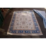 A Chinese cream and blue wool rug,