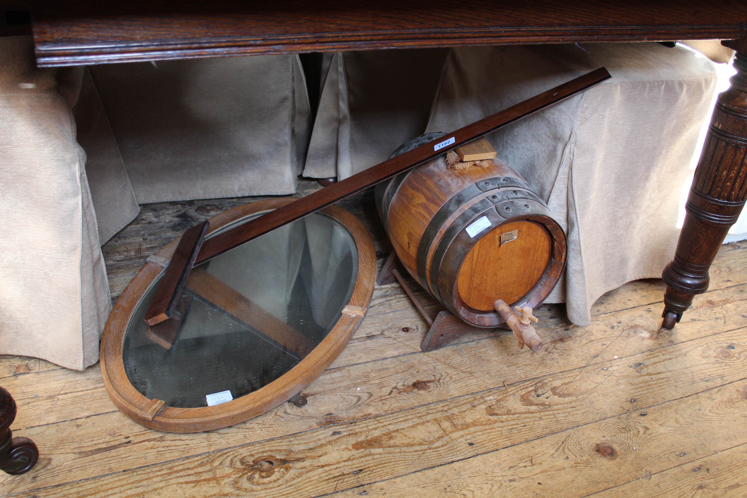 A vintage whisky barrel, oak wall mirror and a mahogany drawing level