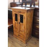 A mango wood small two door cupboard with metal grills