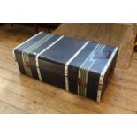 A metal banded and canvas vintage steamer trunk