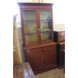 An Edwardian mahogany glazed cupboard/bookcase with two drawers and panelled doors below