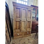 A late 19th Century pine two door wardrobe,