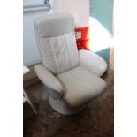 A cream leather Stressless style revolving armchair