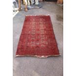 A red ground rug with central medallion design,