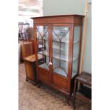 An Edwardian inlaid two door display cabinet on shaped cabriole legs