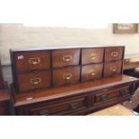 A 1960's bank of eight filing drawers with brass card handles