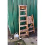 Two vintage step ladders plus a watering can