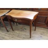 An early 19th Century inlaid mahogany serpentine front card table with central drawer