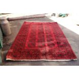 A large wool red and black ground carpet,