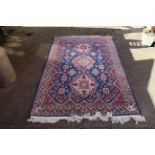 A multi coloured rug with central trio medallion design,